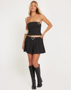 Ayumi Pleated Mini Skirt In Black Pinstripe With Heart Buckle -Outlet Modi Vora Store AYUMI SKIRT BLACK PINSTRIPE 17 W HEART BUCKLE 169014